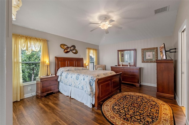 bedroom with ceiling fan, dark wood-type flooring, and vaulted ceiling