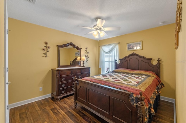 bedroom featuring a textured ceiling, dark hardwood / wood-style flooring, and ceiling fan