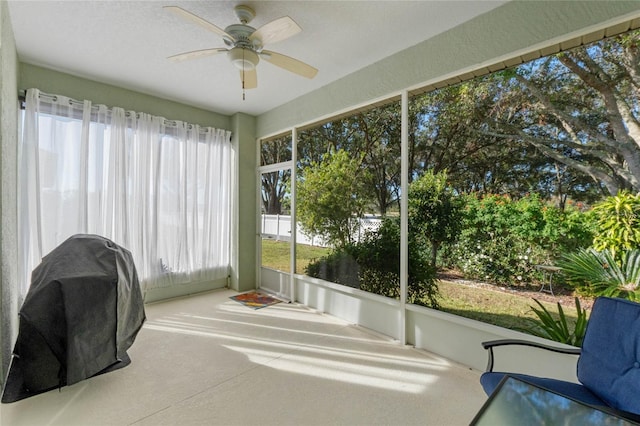 sunroom with ceiling fan and plenty of natural light