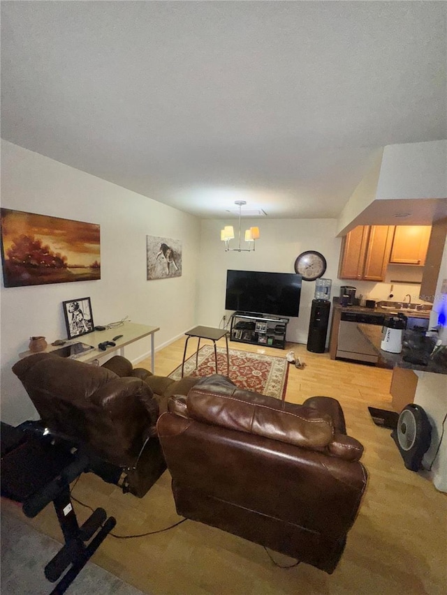 living room featuring sink and a chandelier