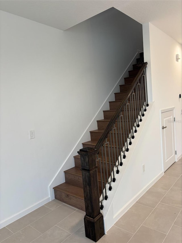 stairs featuring tile patterned floors