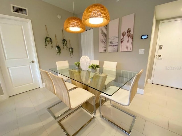 dining area featuring light tile patterned flooring