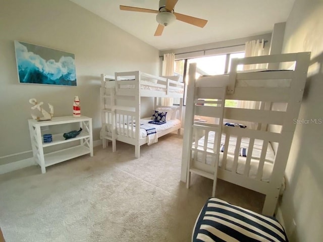 bedroom featuring ceiling fan, carpet floors, and vaulted ceiling