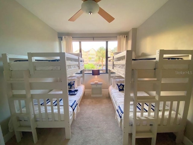 bedroom with light colored carpet, vaulted ceiling, and ceiling fan