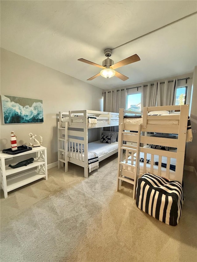 bedroom with a ceiling fan and carpet flooring