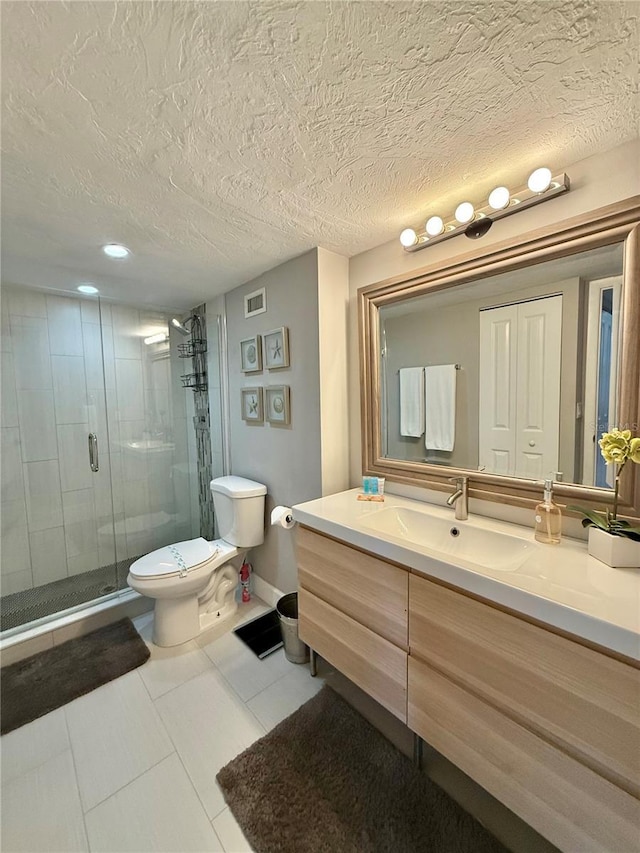 bathroom featuring visible vents, toilet, a textured ceiling, vanity, and a shower stall