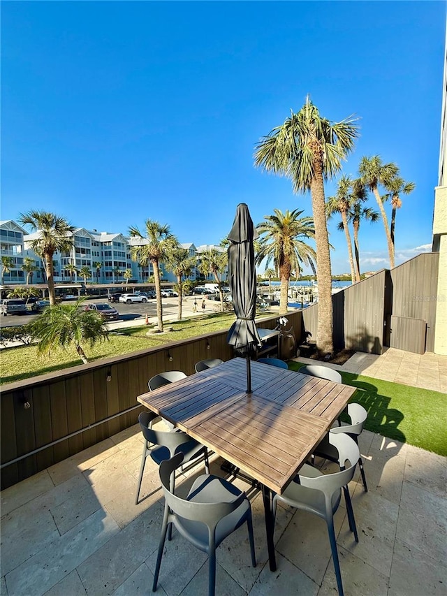 view of patio / terrace featuring fence and outdoor dining area