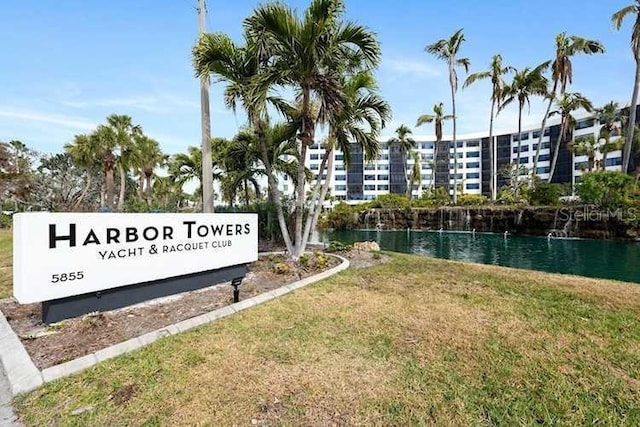 exterior space featuring a water view and a lawn