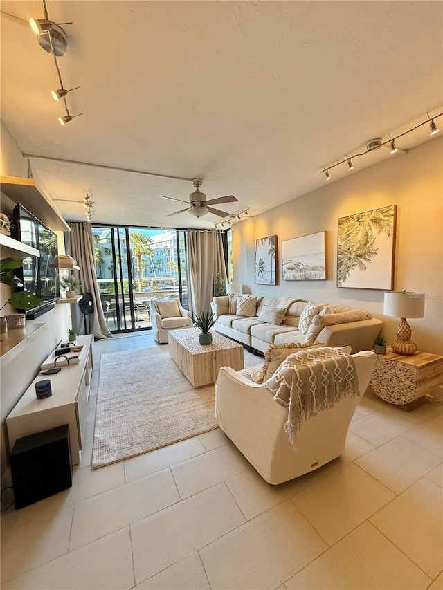 living area featuring light tile patterned floors, expansive windows, a ceiling fan, and track lighting