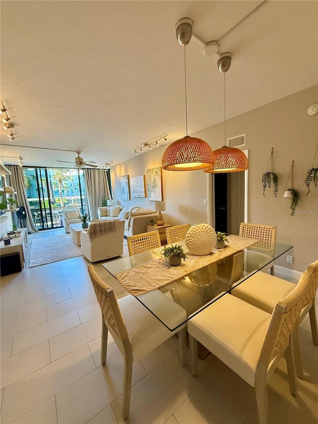 5855 Midnight Pass Rd Unit 108, Sarasota, FL 34242 - dining area with rail lighting, floor to ceiling windows, and light tile patterned floors