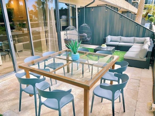 5855 Midnight Pass Rd Unit 108, Sarasota, FL 34242 - balcony with outdoor dining space, a patio area, and an outdoor hangout area
