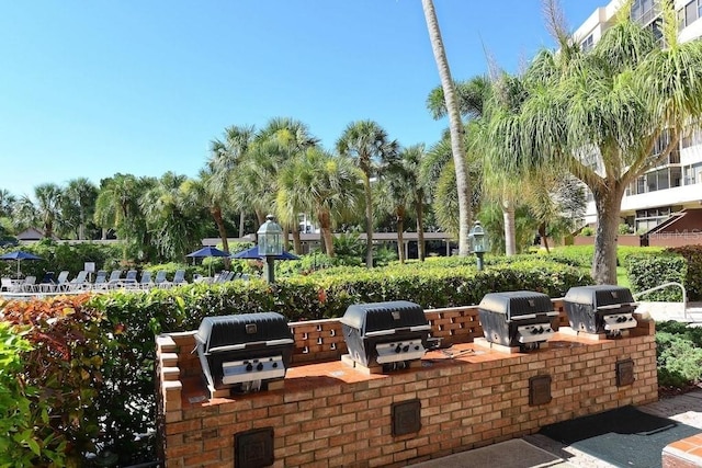5855 Midnight Pass Rd Unit 108, Sarasota, FL 34242 - view of patio with exterior kitchen and area for grilling