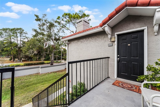 view of exterior entry featuring a yard