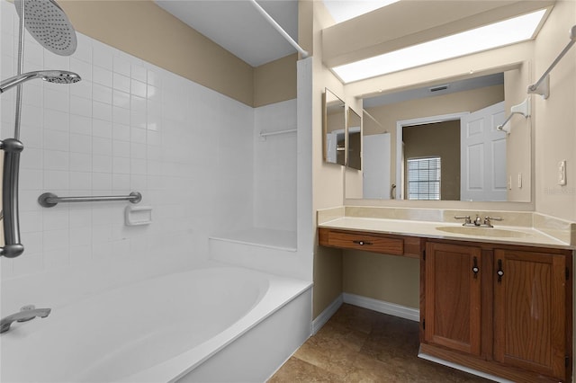 bathroom with vanity and tiled shower / bath combo