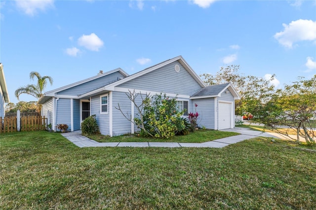 view of front of home with a garage and a front lawn