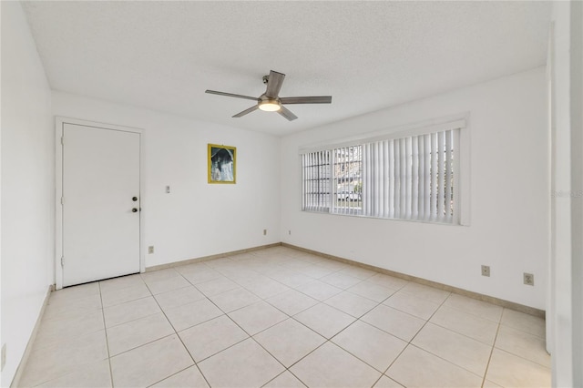 unfurnished room with light tile patterned floors, a textured ceiling, and ceiling fan