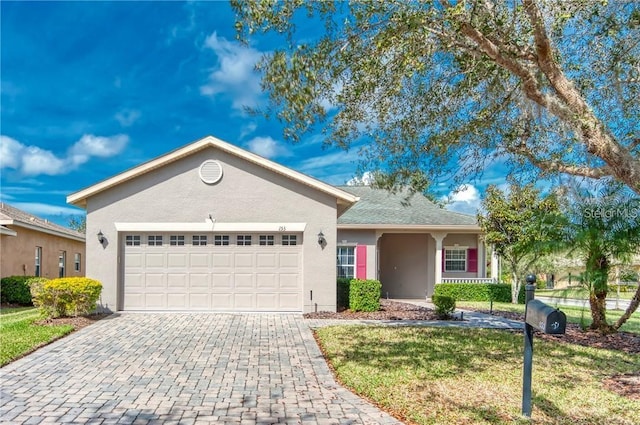 single story home with a garage and a front yard