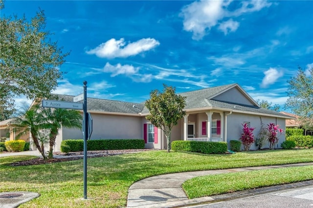 ranch-style house with a porch and a front lawn