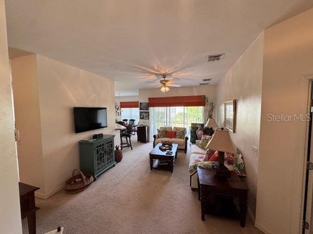 living room with carpet and ceiling fan