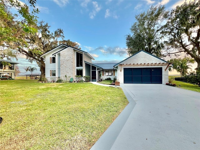 view of front of property with a garage and a front yard