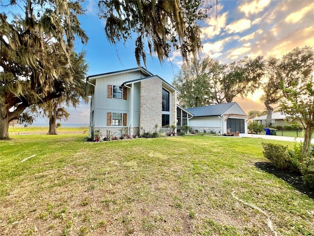 view of front of home with a garage and a yard