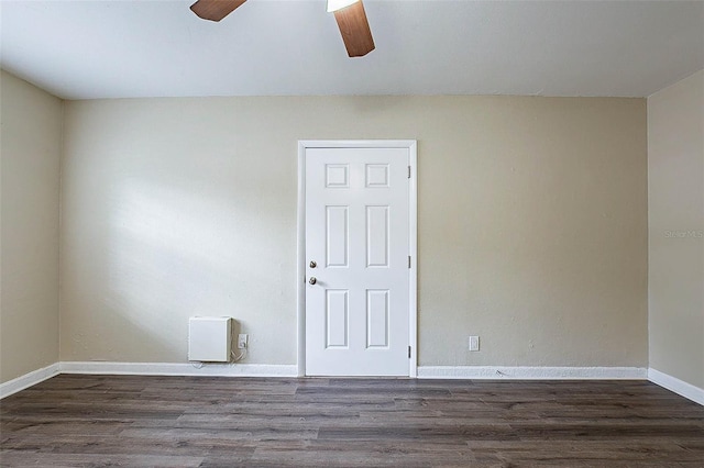 spare room with dark wood-type flooring