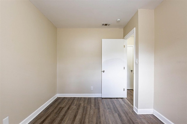 spare room with dark hardwood / wood-style floors