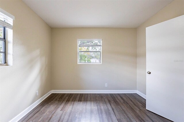 unfurnished room with dark hardwood / wood-style floors