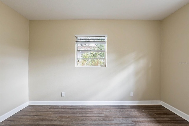 unfurnished room featuring dark wood-type flooring