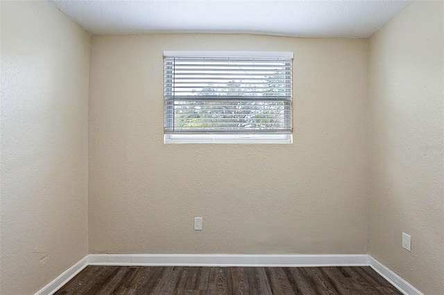 empty room with dark hardwood / wood-style floors