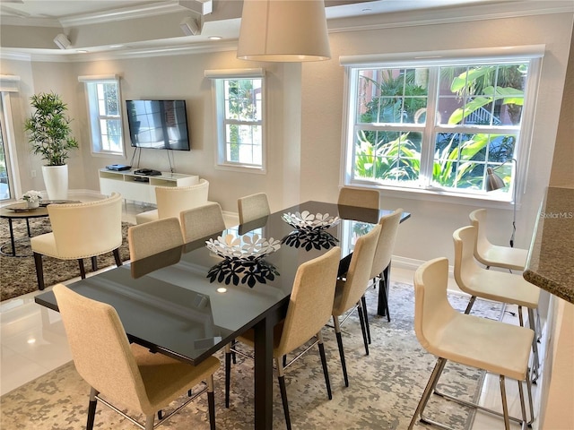 tiled dining room featuring ornamental molding