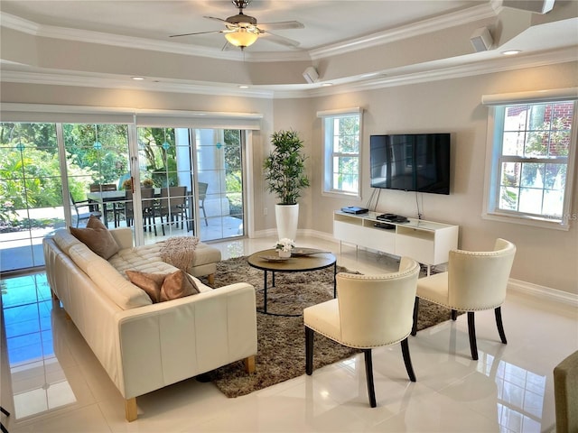 living room with ceiling fan, a healthy amount of sunlight, light tile patterned flooring, and crown molding