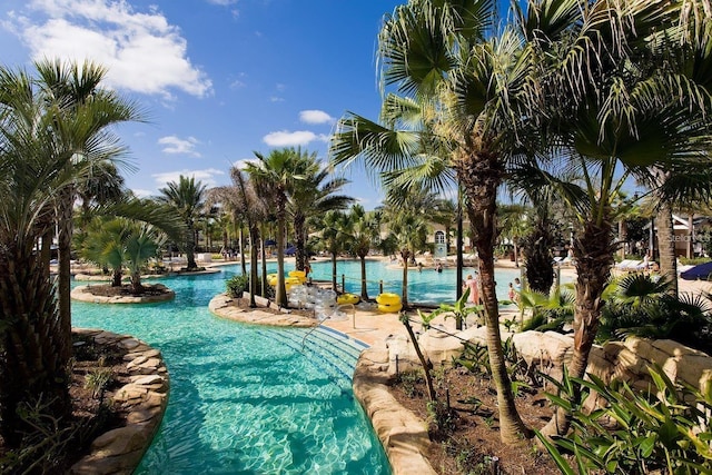 view of pool featuring a water view