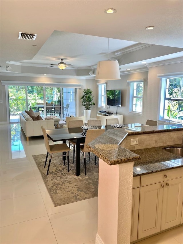 7652 Whisper Way Unit 104, Reunion, FL 34747 - dining space featuring a raised ceiling, ornamental molding, recessed lighting, light tile patterned flooring, and ceiling fan