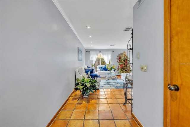 hallway featuring light tile patterned flooring and ornamental molding