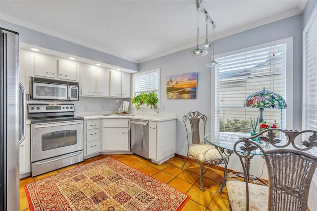 kitchen with white cabinetry, sink, rail lighting, stainless steel appliances, and light tile patterned floors