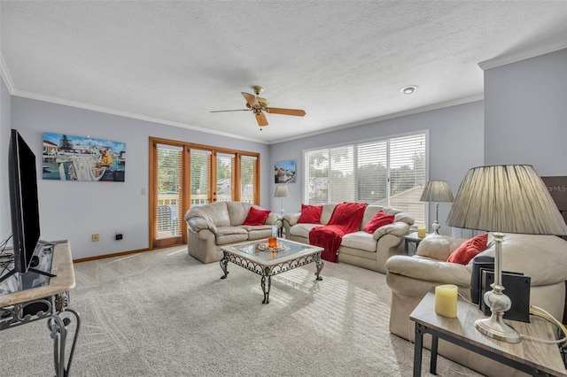 carpeted living room featuring crown molding, plenty of natural light, ceiling fan, and a textured ceiling