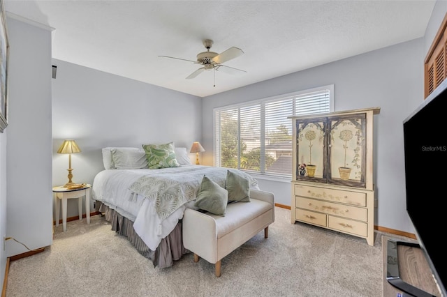 bedroom featuring ceiling fan and light carpet