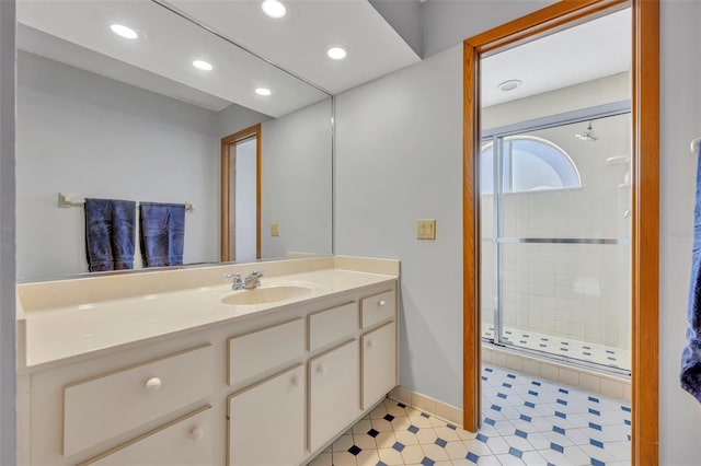 bathroom with vanity and a shower with shower door