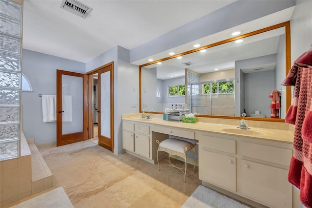 bathroom featuring french doors, vanity, and independent shower and bath