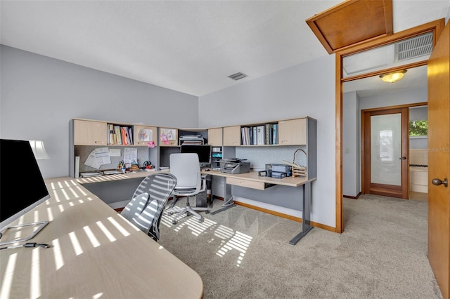 home office with french doors and light colored carpet