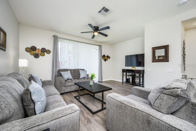 living room with ceiling fan and wood-type flooring