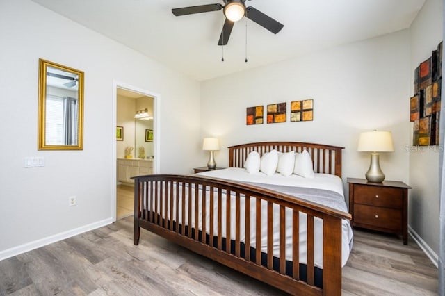 bedroom with connected bathroom, hardwood / wood-style flooring, and ceiling fan