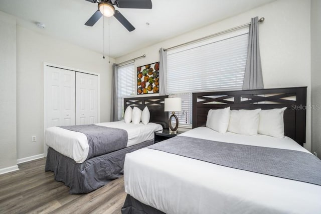 bedroom with hardwood / wood-style floors, a closet, and ceiling fan