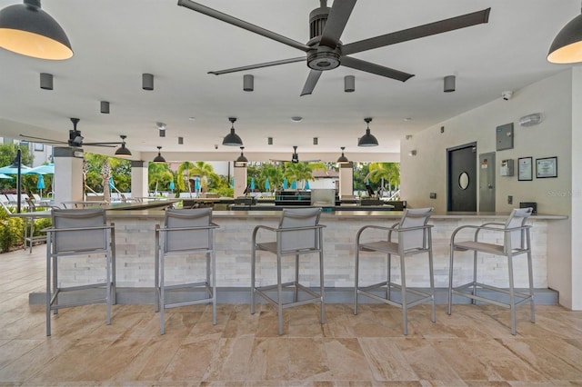 view of patio / terrace with ceiling fan and an outdoor bar