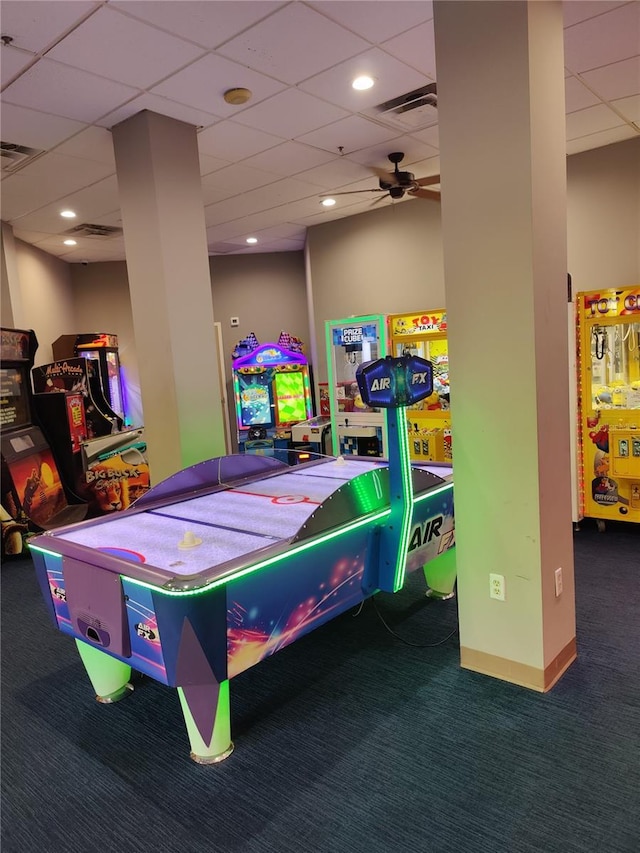 recreation room with a paneled ceiling, ceiling fan, and carpet floors