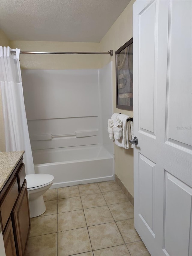 full bathroom with toilet, vanity, a textured ceiling, and tile patterned floors