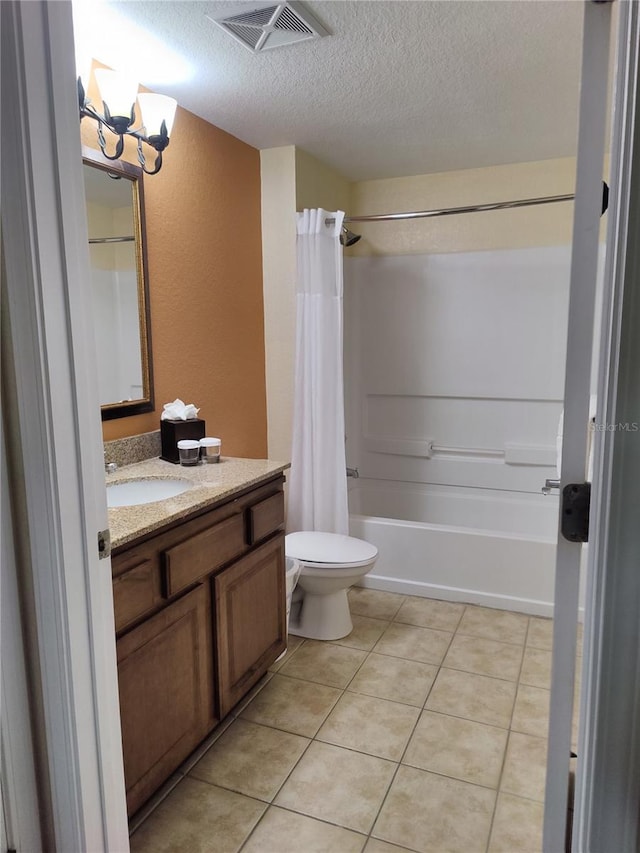 full bathroom with vanity, tile patterned floors, toilet, a textured ceiling, and a notable chandelier