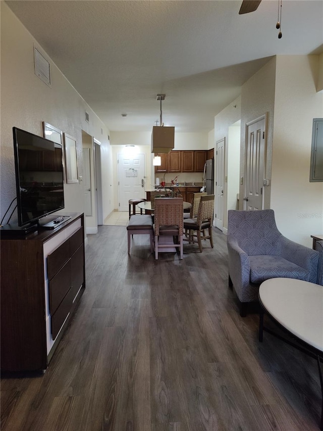 dining area featuring ceiling fan and dark wood-type flooring