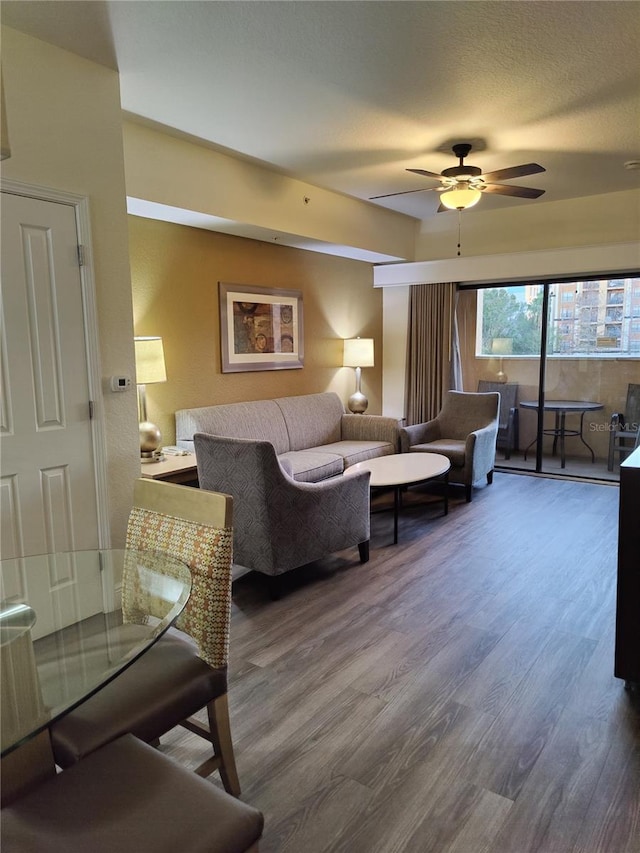 living room featuring ceiling fan and hardwood / wood-style floors